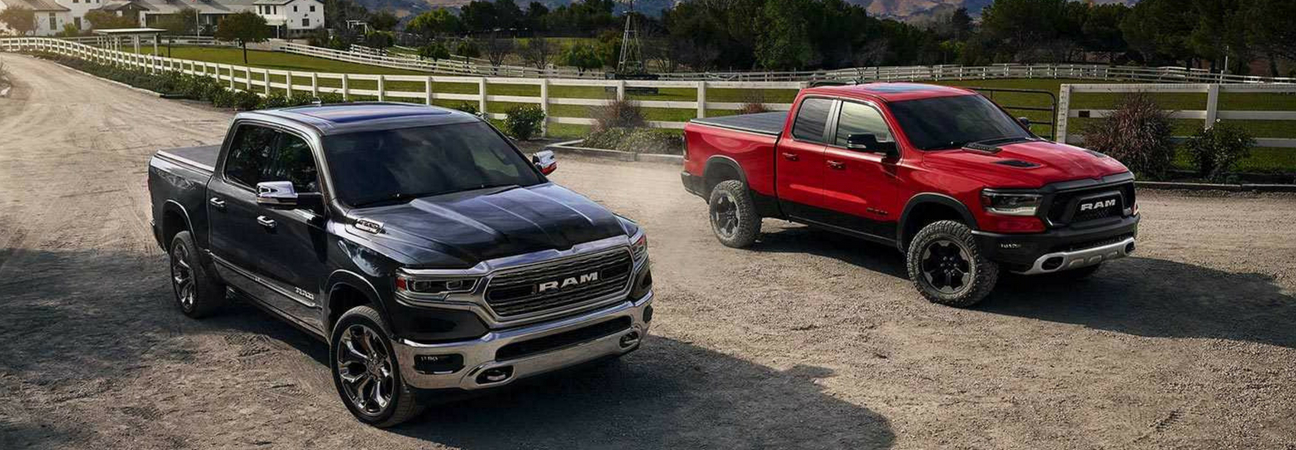 2019 RAM 1500 trucks driving down dirt road